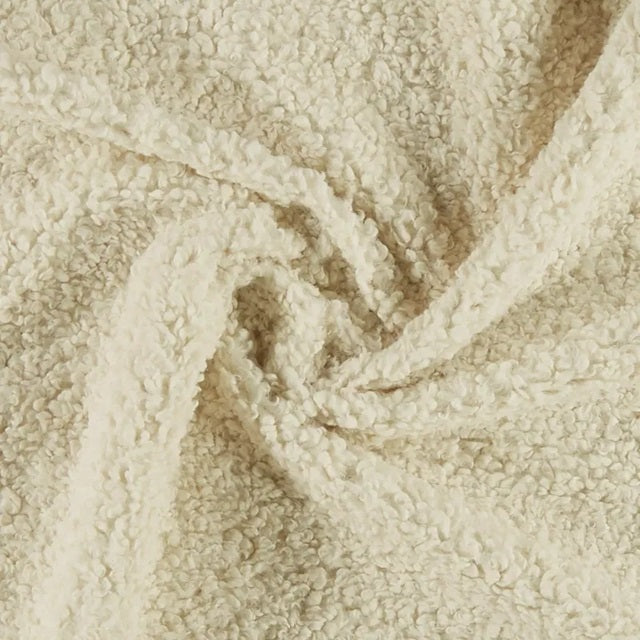 Close-up of beige textured fabric with a subtle pattern