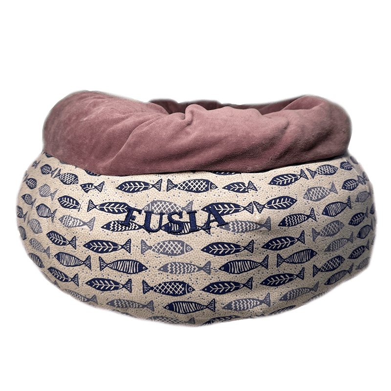 Pet bed with fish pattern and 'Fusia' branding on a green background