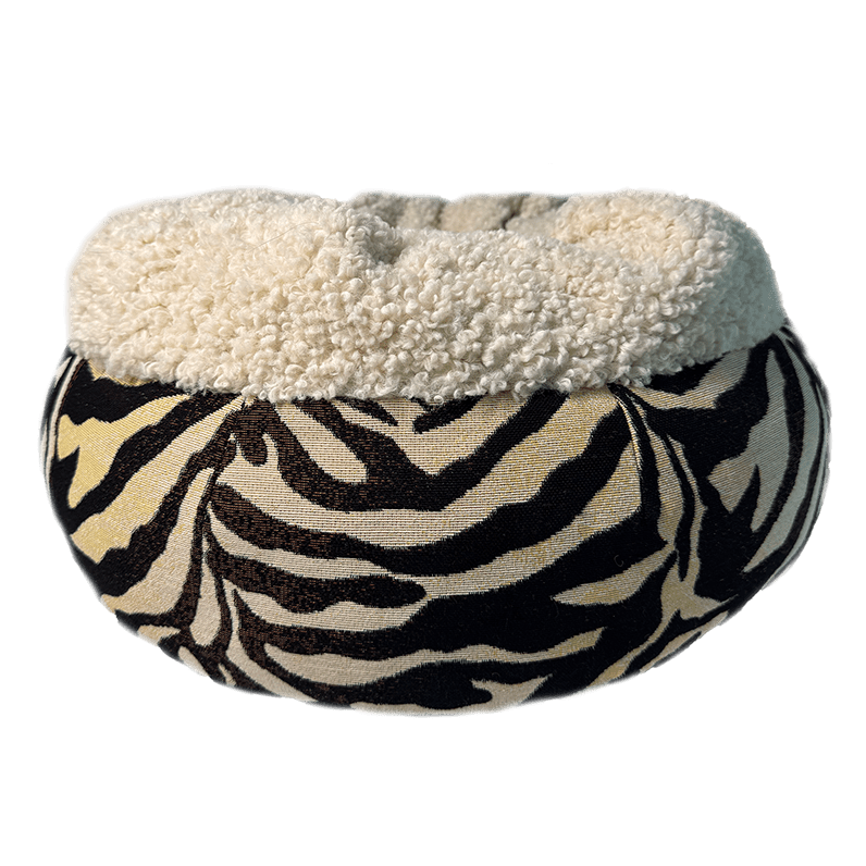 Zebra print pet bed with white fleece lining on a transparent background
