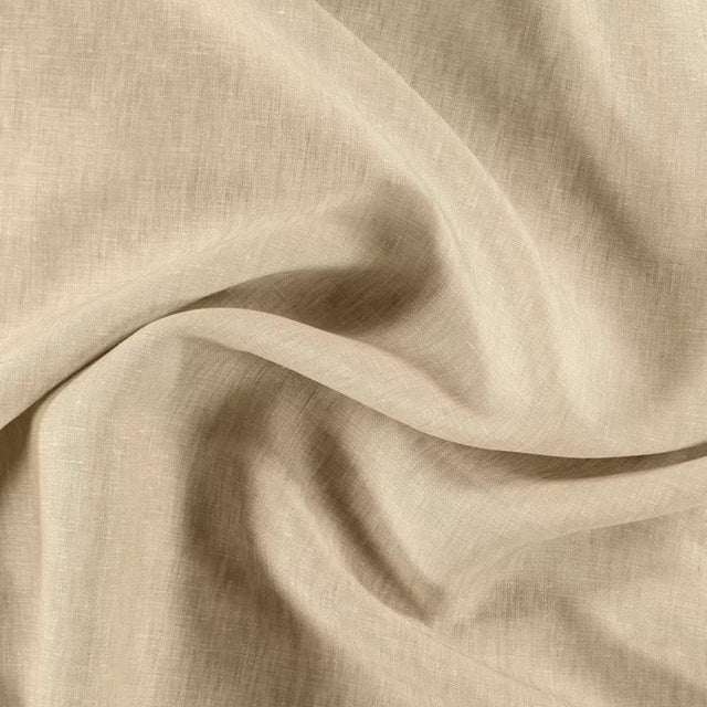 Beige fabric with a soft texture and subtle patterns