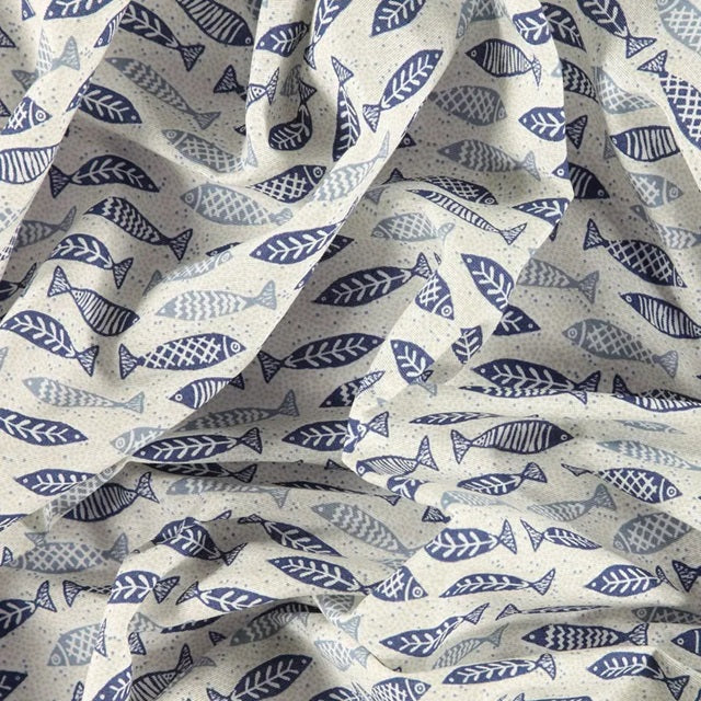 Fabric with blue fish pattern on a beige background